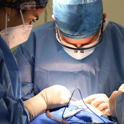 Dermatologist performing surgery on a patient, representing Mohs skin cancer surgery in Virginia Beach