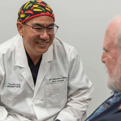 Dr. Chang meeting and talking to a patient, representing your first dermatology appointment