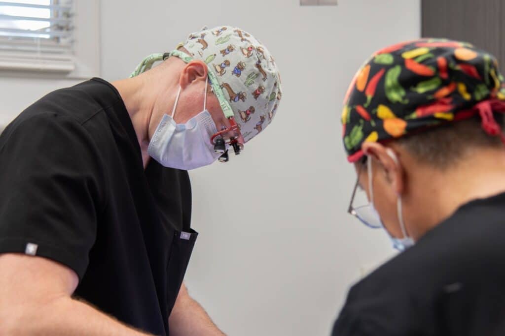 Dermatologists treating a patient in chair